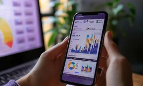 Hands Holding a Phone With Analytics Displayed